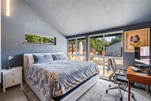 a bedroom with a bed and a desk