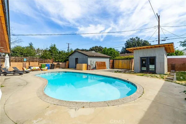 a view of a swimming pool with a yard