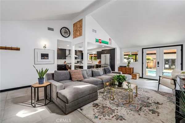 a living room with furniture a clock and a window