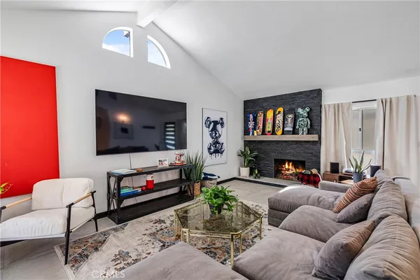 a living room with fireplace furniture and a flat screen tv