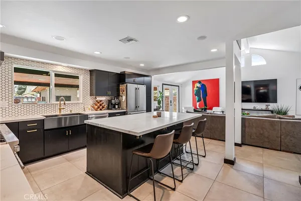 a kitchen with stainless steel appliances kitchen island granite countertop a sink and cabinets