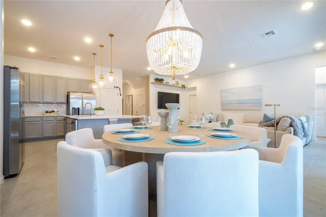 a view of a dining room with furniture wooden floor and a chandelier