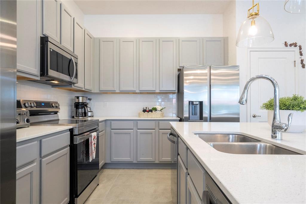5887 High Seas Drive Orlando, FL 32821 - Photo 15 of 93 a kitchen with stainless steel appliances granite countertop a sink a stove and cabinets