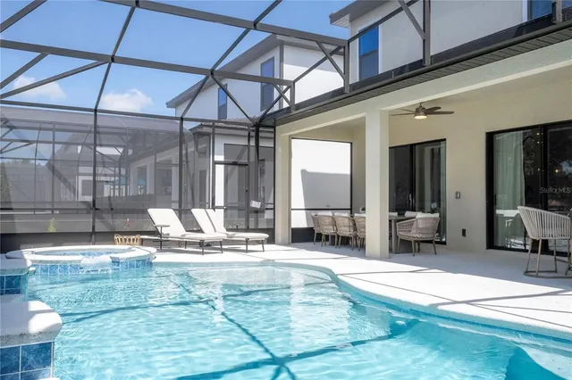 a living room with furniture and a painting on the wall