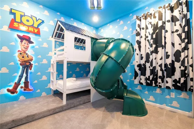 a bedroom with a bed and a painting on the wall