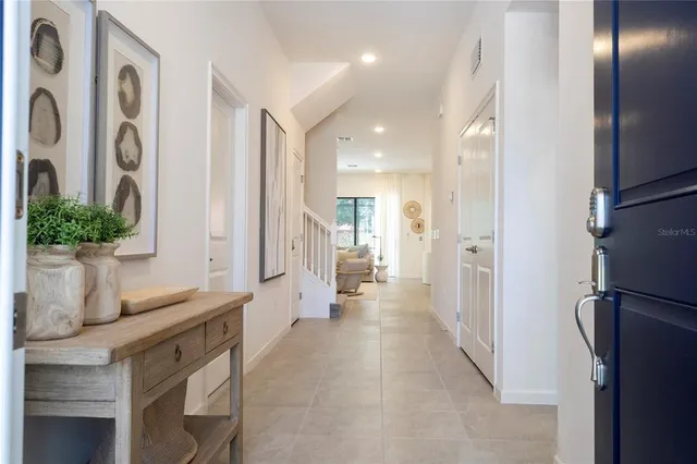 a bedroom with a bed and a potted plant on dresser