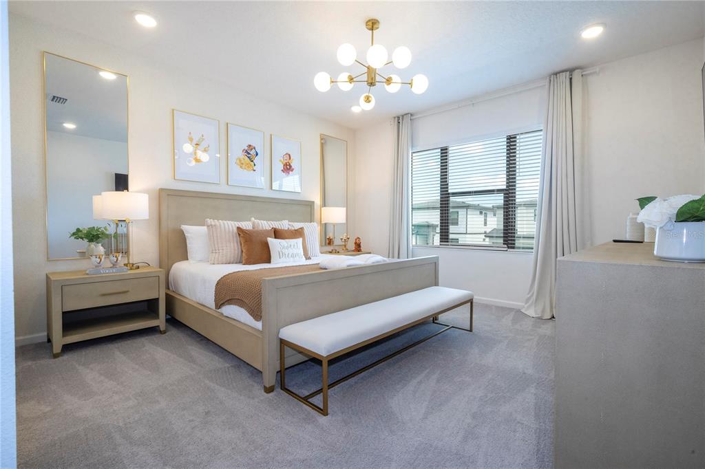 5887 High Seas Drive Orlando, FL 32821 - Photo 45 of 93 a bedroom with a bed and a chandelier
