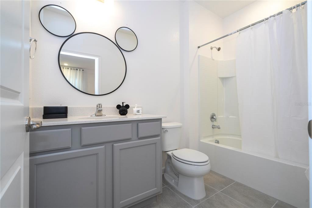 5887 High Seas Drive Orlando, FL 32821 - Photo 62 of 93 a bathroom with a toilet a sink and a mirror
