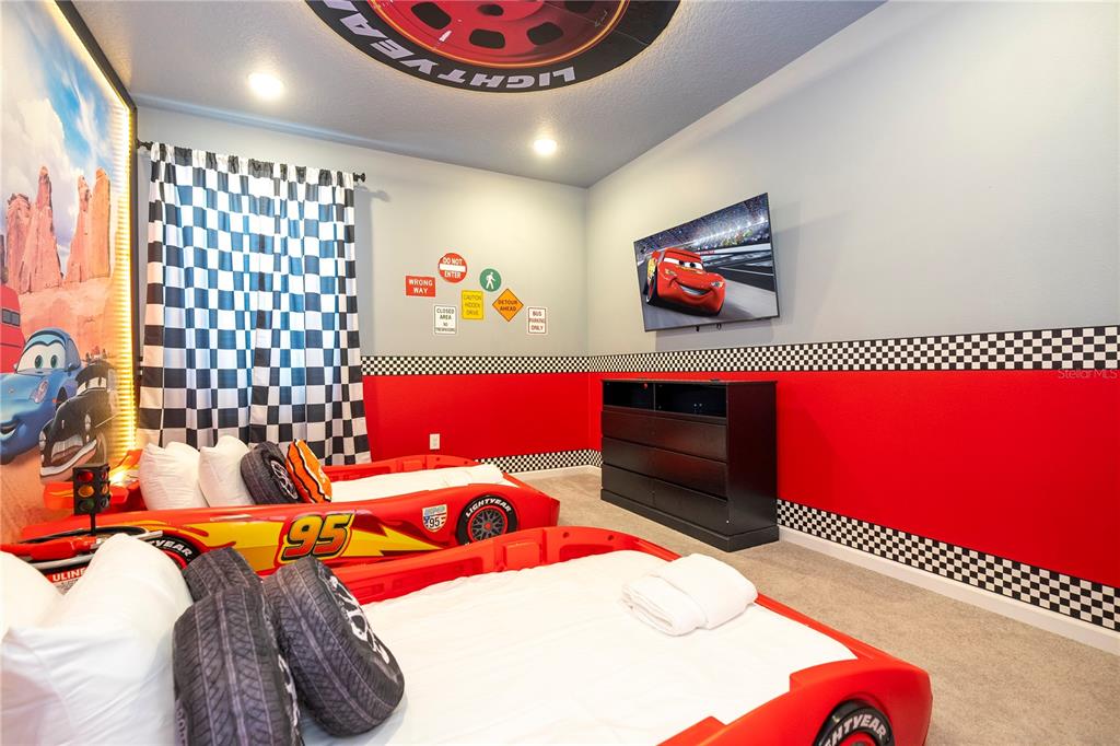 5887 High Seas Drive Orlando, FL 32821 - Photo 67 of 93 a bedroom with a bed and a painting on the wall