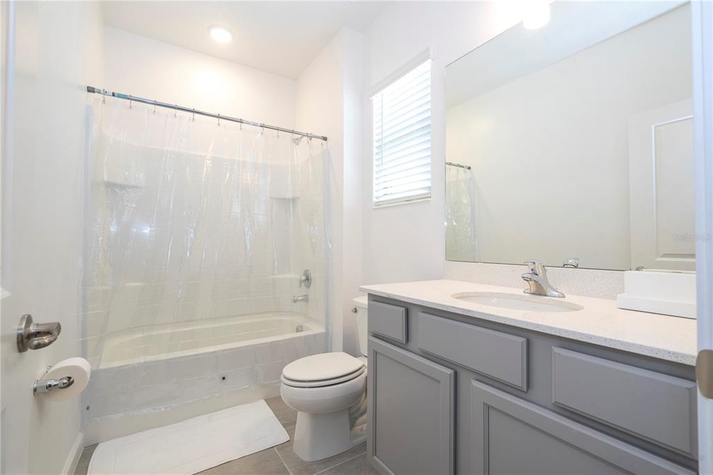 5887 High Seas Drive Orlando, FL 32821 - Photo 68 of 93 a bathroom with a sink a toilet and shower