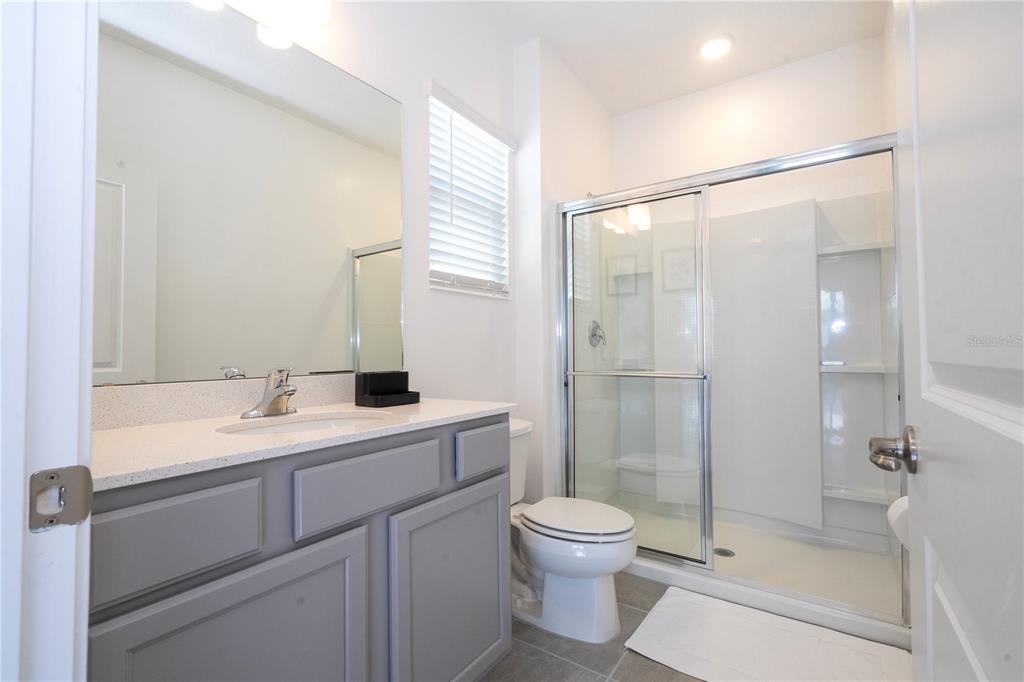 5887 High Seas Drive Orlando, FL 32821 - Photo 75 of 93 a bathroom with a sink a toilet and shower