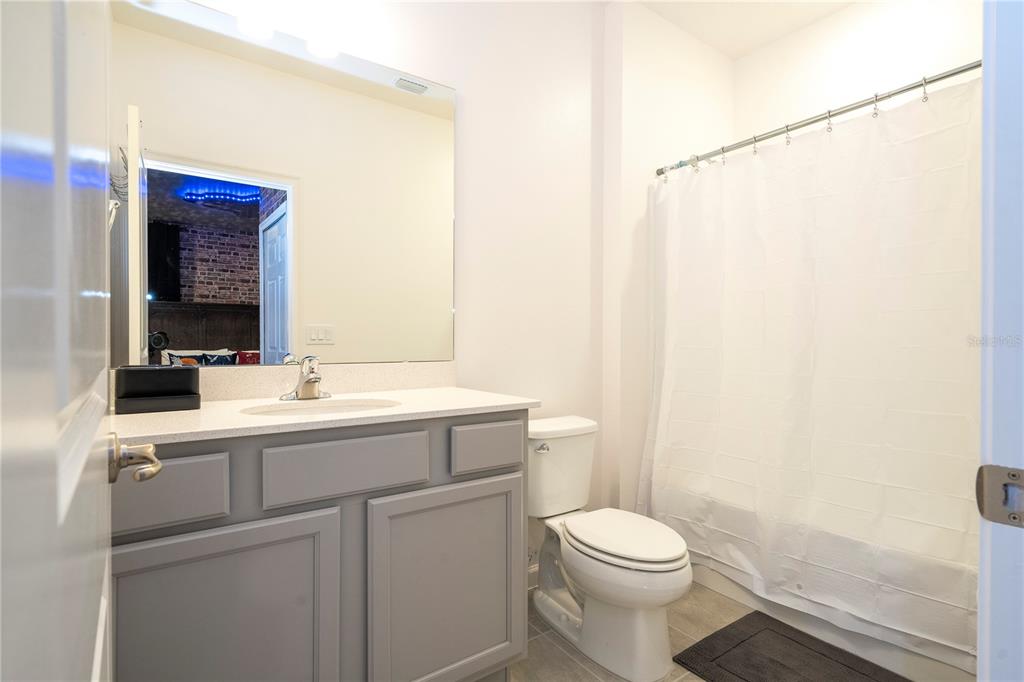 5887 High Seas Drive Orlando, FL 32821 - Photo 81 of 93 a bathroom with a sink a toilet and a mirror