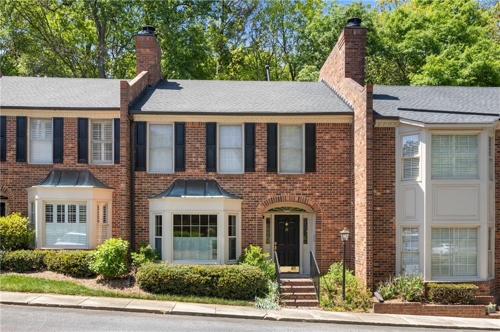 26 Howell Mill Road Northwest Atlanta, GA 30327 - Photo 1 of 33 a aerial view of a brick house next to a yard