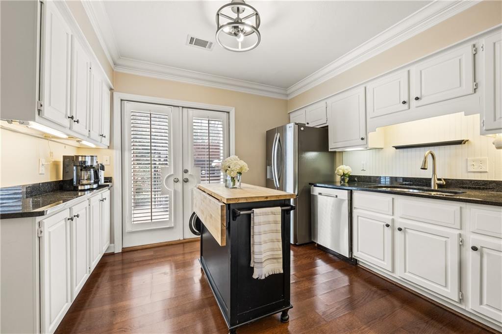 26 Howell Mill Road Northwest Atlanta, GA 30327 - Photo 11 of 33 a kitchen with stainless steel appliances granite countertop a refrigerator a stove and white cabinets
