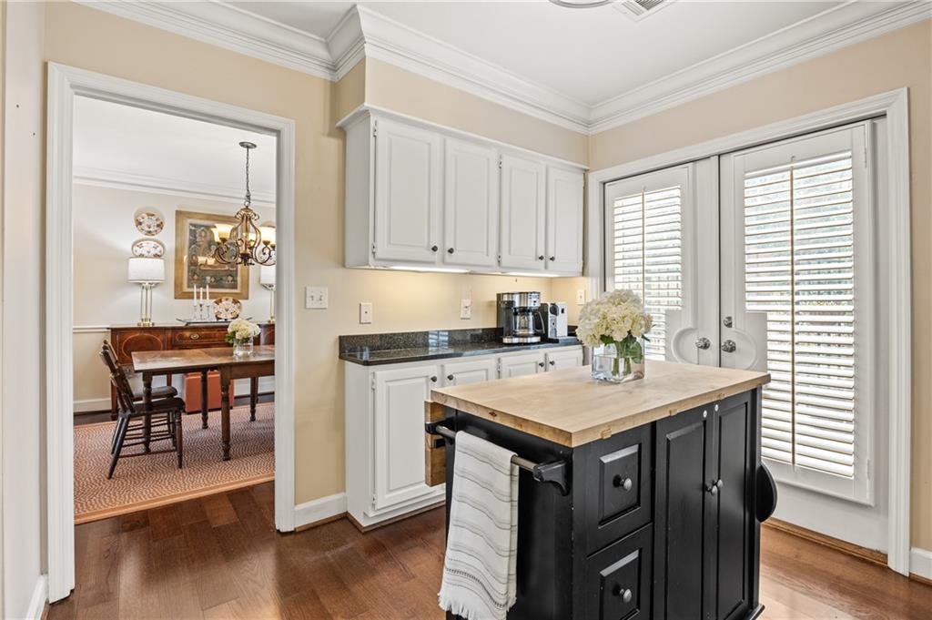 26 Howell Mill Road Northwest Atlanta, GA 30327 - Photo 12 of 33 a kitchen with a stove a sink a dining table and chairs