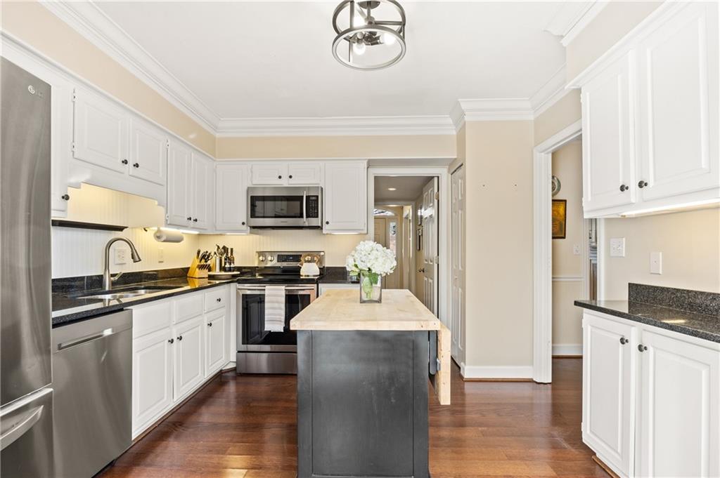 26 Howell Mill Road Northwest Atlanta, GA 30327 - Photo 13 of 33 a large kitchen with stainless steel appliances granite countertop a stove top oven a sink dishwasher and a refrigerator