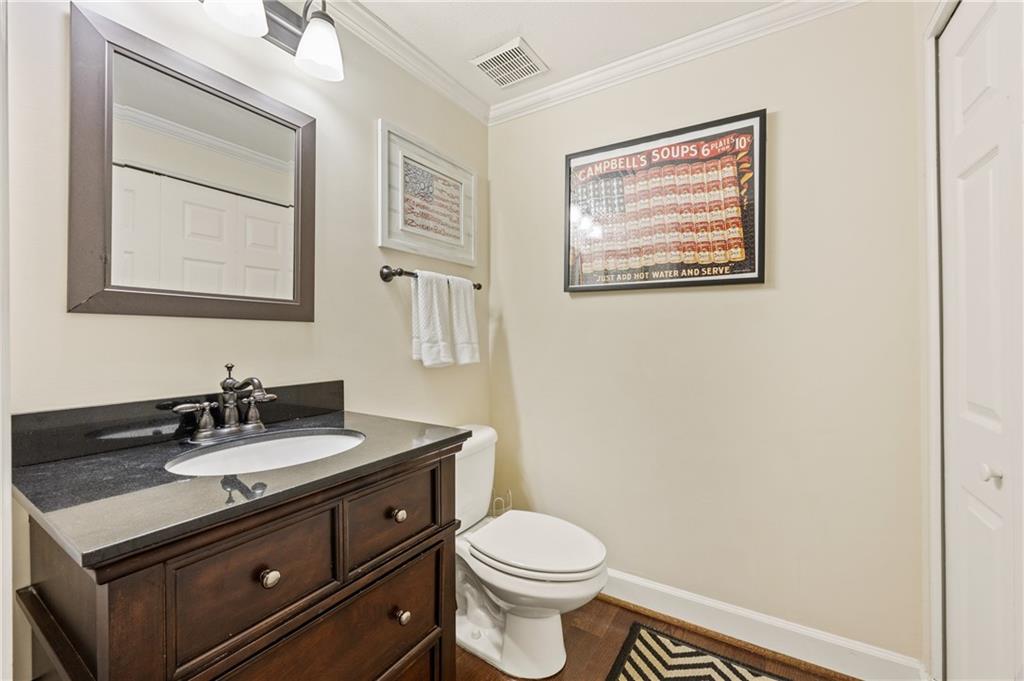 26 Howell Mill Road Northwest Atlanta, GA 30327 - Photo 14 of 33 a bathroom with a toilet a sink and mirror