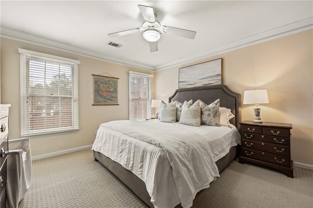 26 Howell Mill Road Northwest Atlanta, GA 30327 - Photo 15 of 33 a bedroom with a bed a chandelier and a dresser