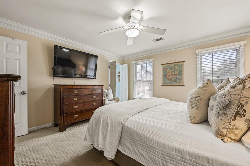 26 Howell Mill Road Northwest Atlanta, GA 30327 - Photo 16 of 33 a bedroom with a bed and a flat screen tv