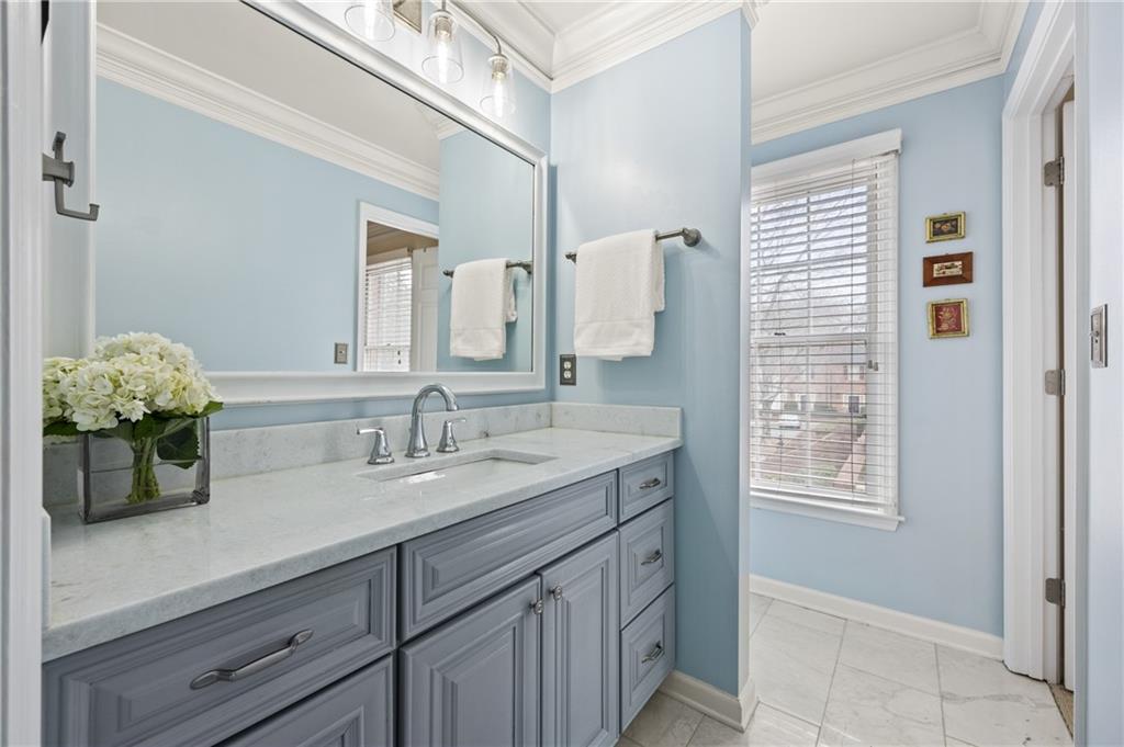 26 Howell Mill Road Northwest Atlanta, GA 30327 - Photo 18 of 33 a bathroom with a sink a vanity and a mirror