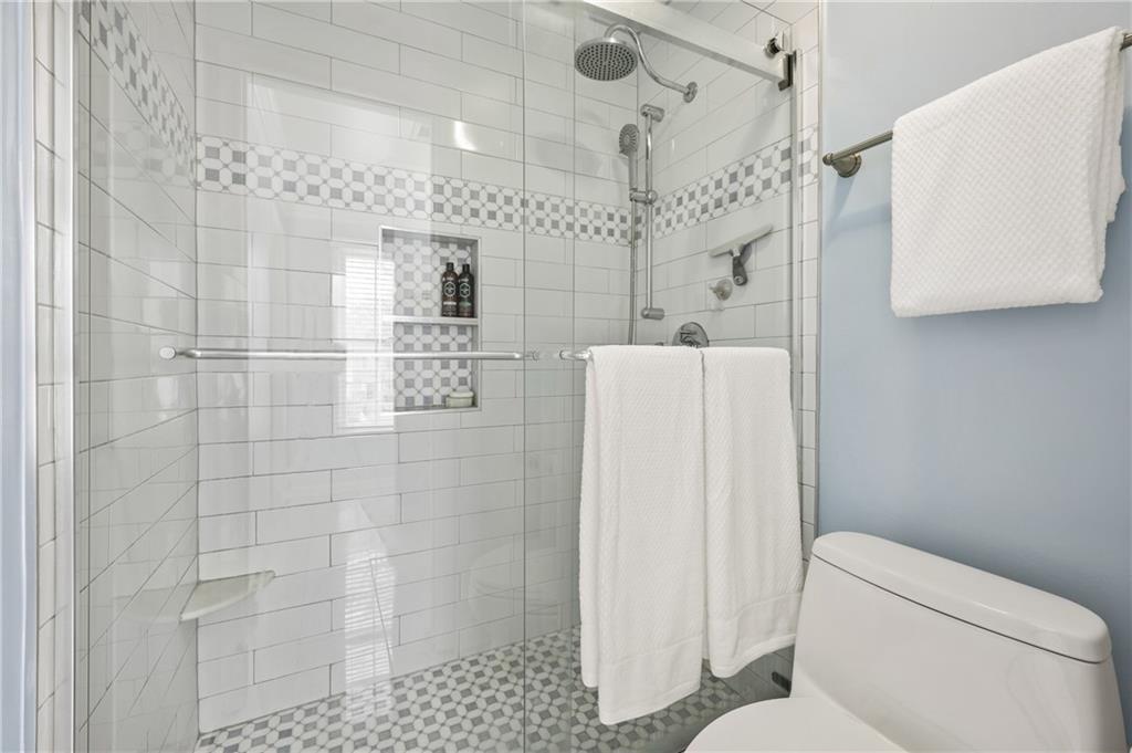 26 Howell Mill Road Northwest Atlanta, GA 30327 - Photo 19 of 33 a bathroom with a shower a toilet and a shower