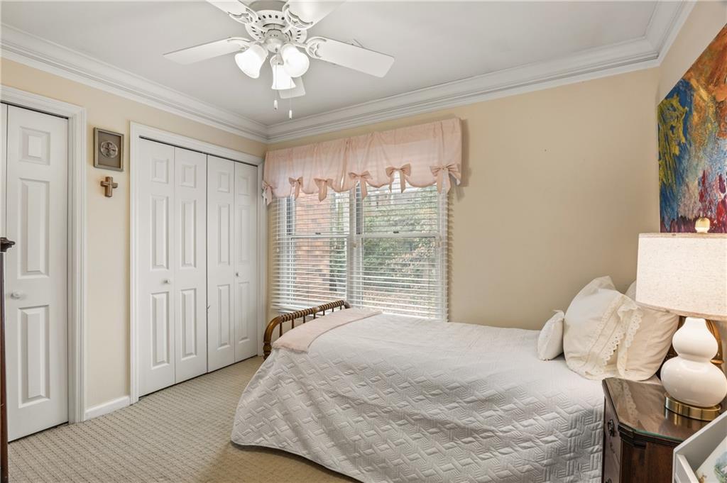 26 Howell Mill Road Northwest Atlanta, GA 30327 - Photo 20 of 33 a bedroom with a large bed and a chandelier