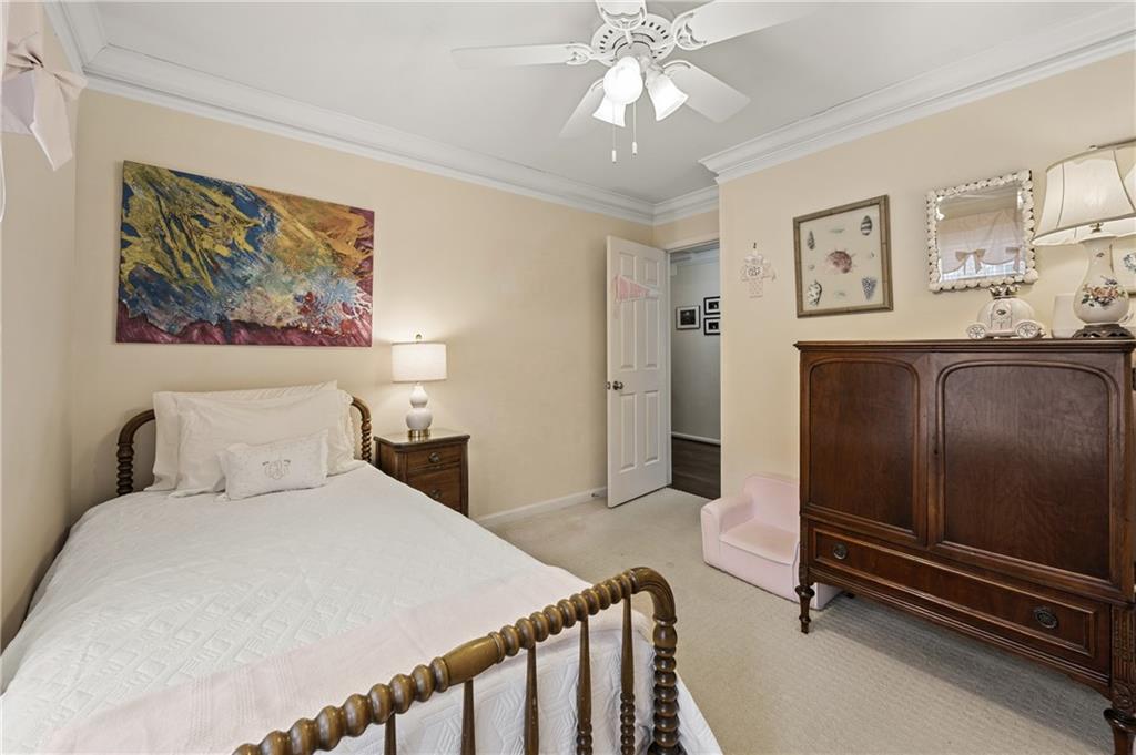 26 Howell Mill Road Northwest Atlanta, GA 30327 - Photo 21 of 33 a bedroom with a bed and a chandelier