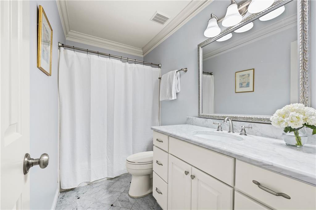 26 Howell Mill Road Northwest Atlanta, GA 30327 - Photo 23 of 33 a bathroom with a granite countertop sink a toilet and a mirror