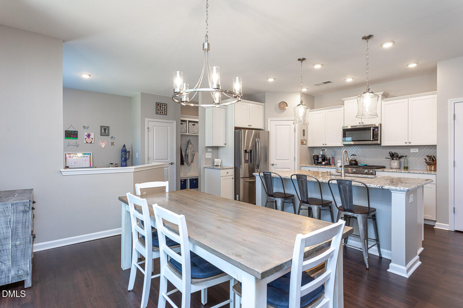 1708 Highpoint Street Wake Forest, NC 27587 - Photo 8 of 63 a kitchen with stainless steel appliances granite countertop a kitchen island a stove a table and chairs