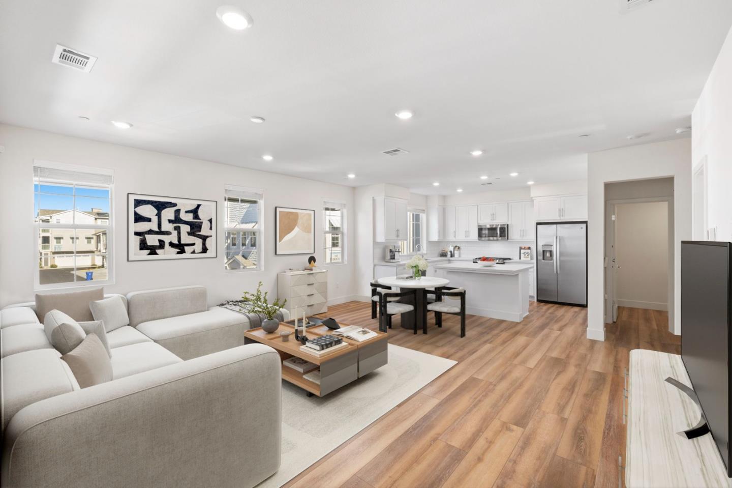 a living room with furniture and kitchen view