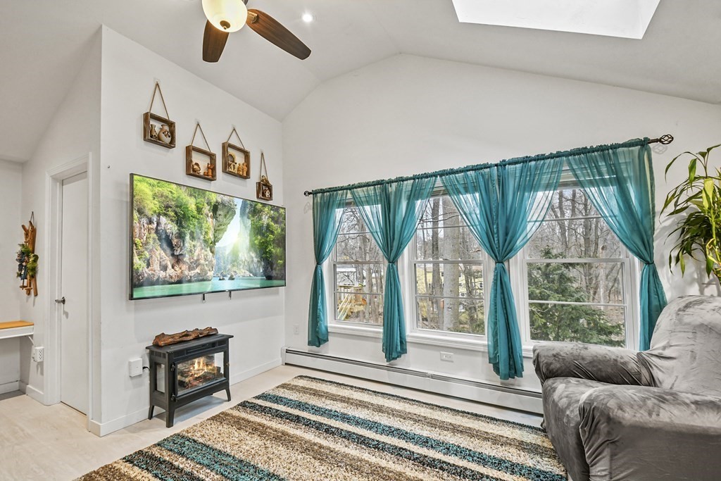36 Inwood Road Auburn, MA 01501 - Photo 16 of 39 a living room with furniture and a floor to ceiling window