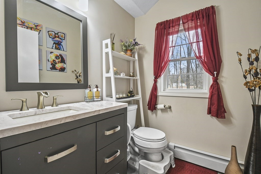 36 Inwood Road Auburn, MA 01501 - Photo 17 of 39 a bathroom with a toilet a sink and a window
