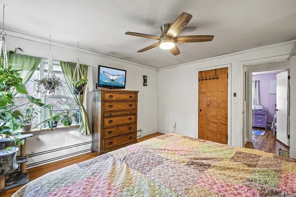 36 Inwood Road Auburn, MA 01501 - Photo 20 of 39 a bedroom with a bed and a chandelier
