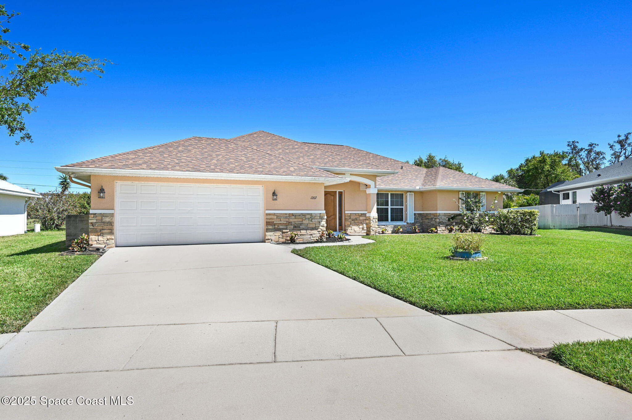 1207 Van Tassel Trail Palm Bay, FL 32905 - Photo 3 of 28 a front view of a house with a yard