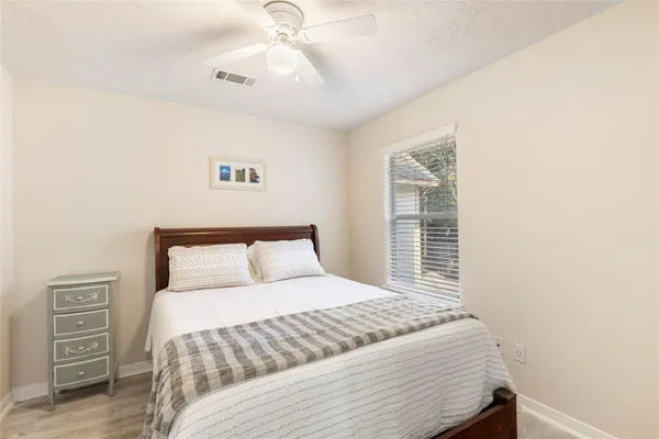 a bedroom with a large bed and a window