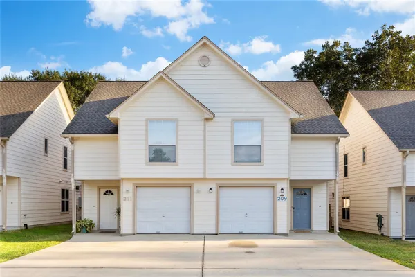 a view of a house with a yard and garage