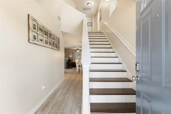 a view of entryway and hall with wooden floor