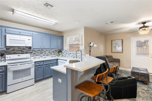 a open kitchen with stainless steel appliances kitchen island granite countertop a sink and cabinets