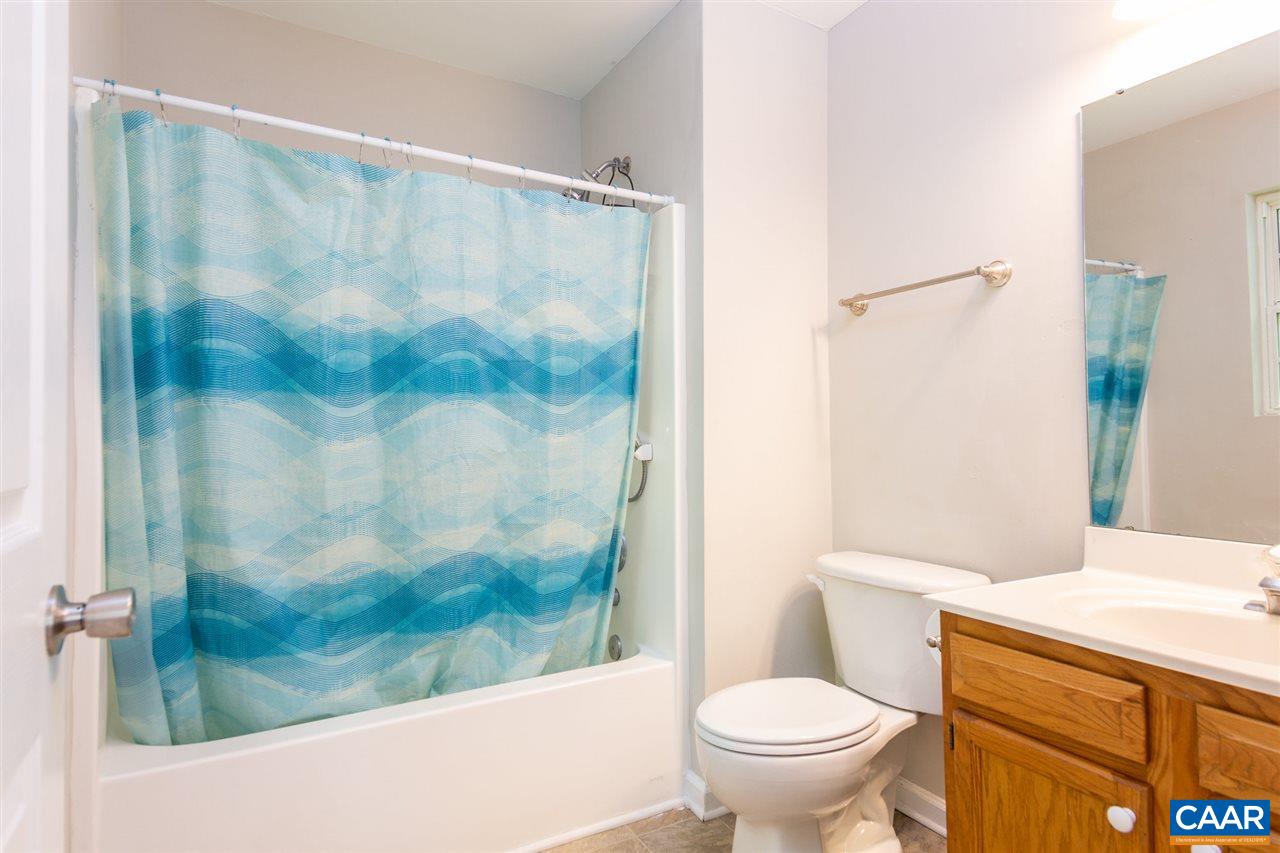 18 East Point Road Palmyra, VA 22963 - Photo 14 of 20 a white toilet sitting next to a bathroom sink