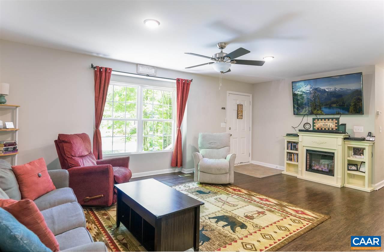 18 East Point Road Palmyra, VA 22963 - Photo 5 of 20 a living room with furniture a flat screen tv and a fireplace