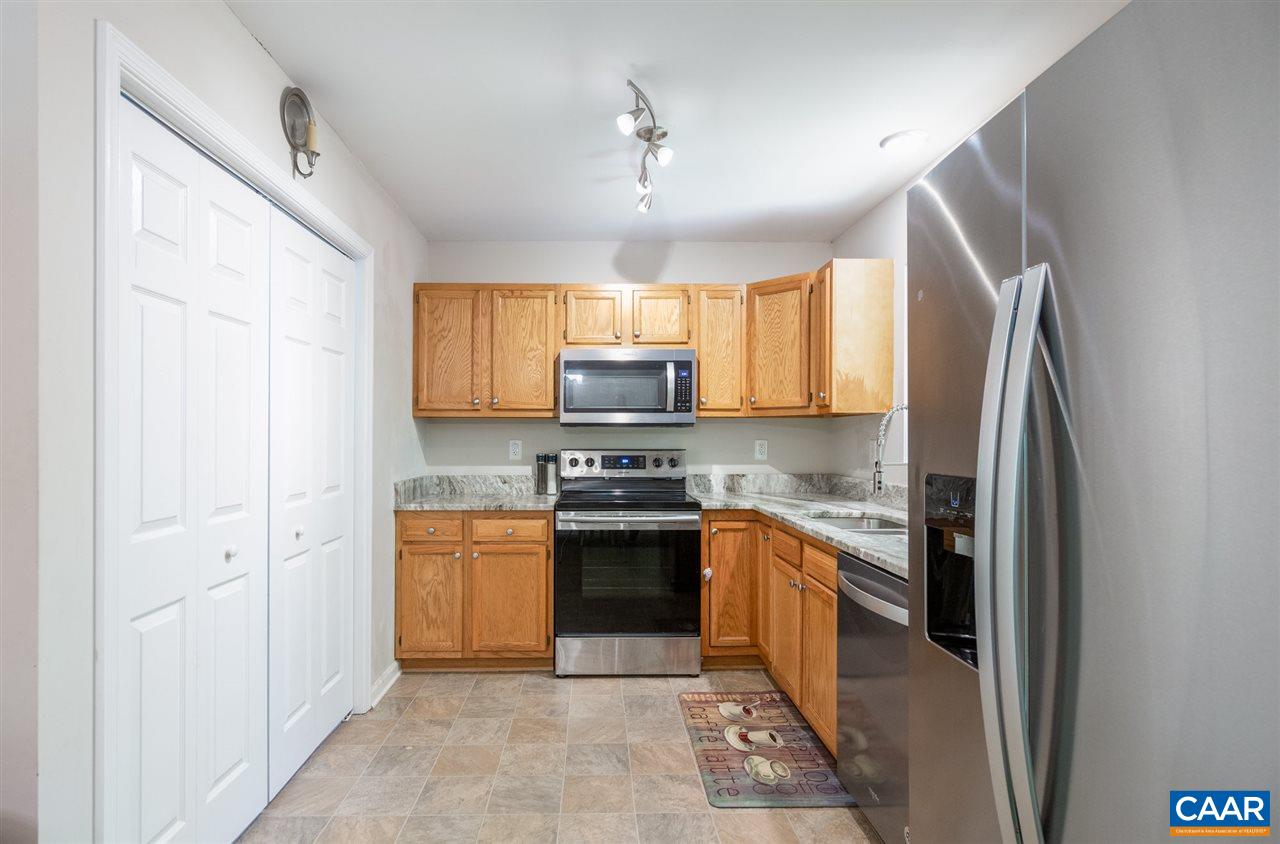 18 East Point Road Palmyra, VA 22963 - Photo 8 of 20 a kitchen with stainless steel appliances granite countertop a refrigerator a sink dishwasher a stove and a microwave oven with wooden floor