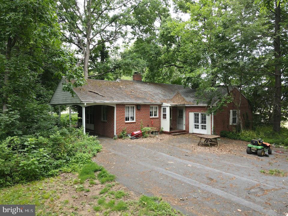 1733 Lancaster Road Manheim, PA 17545 - Photo 5 of 22 a front view of a house with trees and plants