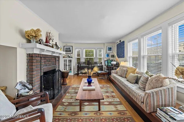 a living room with furniture fireplace and a large window
