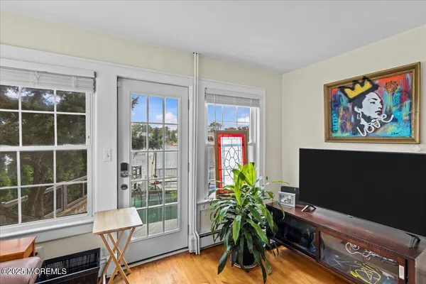 a living room with furniture potted plant and a flat screen tv