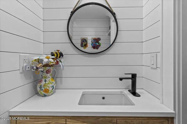 a bathroom with a sink and mirror