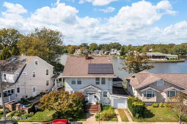 an aerial view of multiple houses with a yard