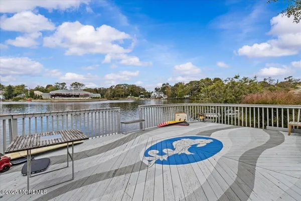 a view of a roof deck with chair and wooden floor