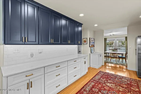 a kitchen with granite countertop wooden cabinets a sink and dishwasher