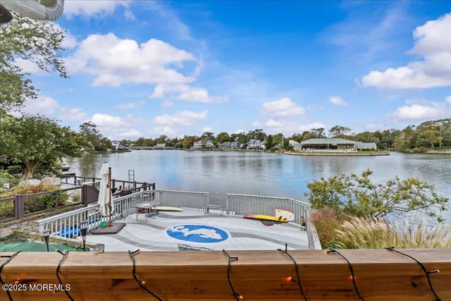 a view of a lake with couches and city view