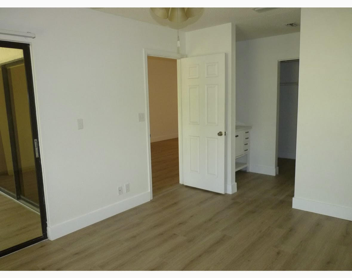 3130 Millwood Terrace, Unit 2120 Boca Raton, FL 33431 - Photo 13 of 15 a view of a hallway with wooden floor